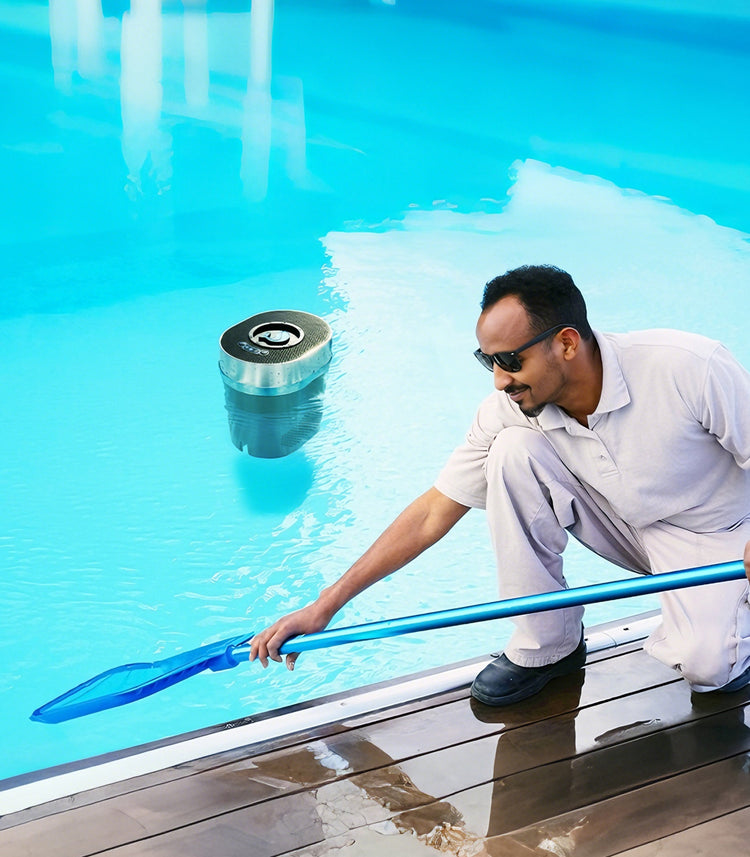 FinWhale Smart Chlorine Dispenser floating in a clear swimming pool